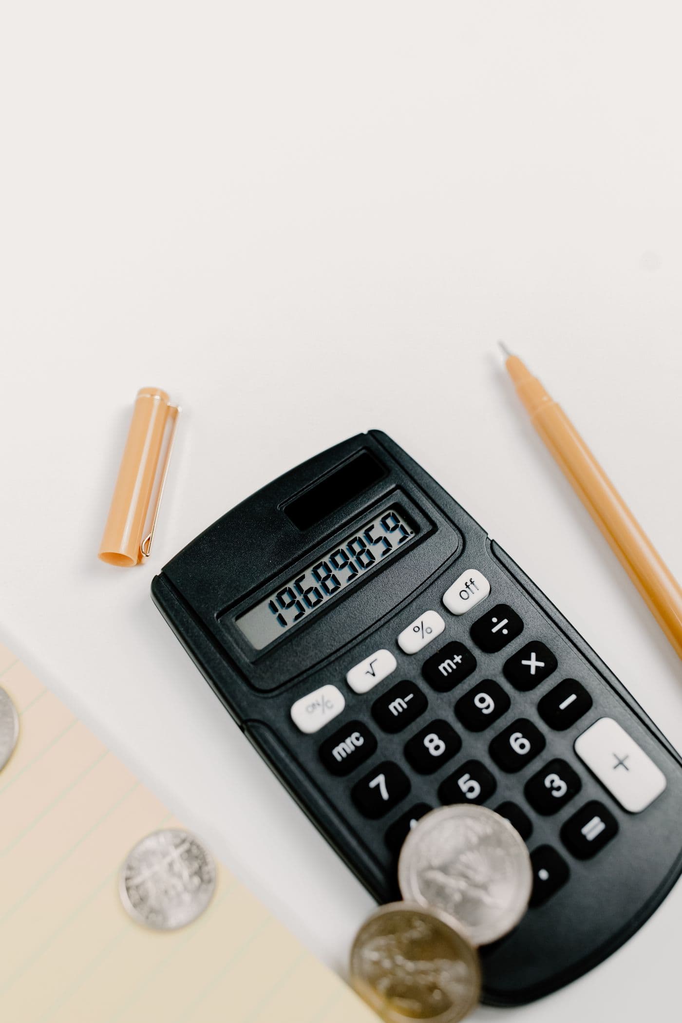 A calculator and pencil on a desk for estimating repair costs