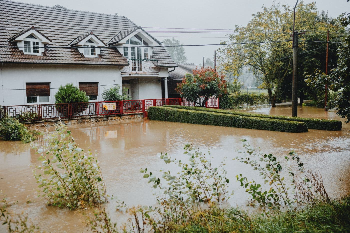 Floodwater standing across the floor and yard of a home