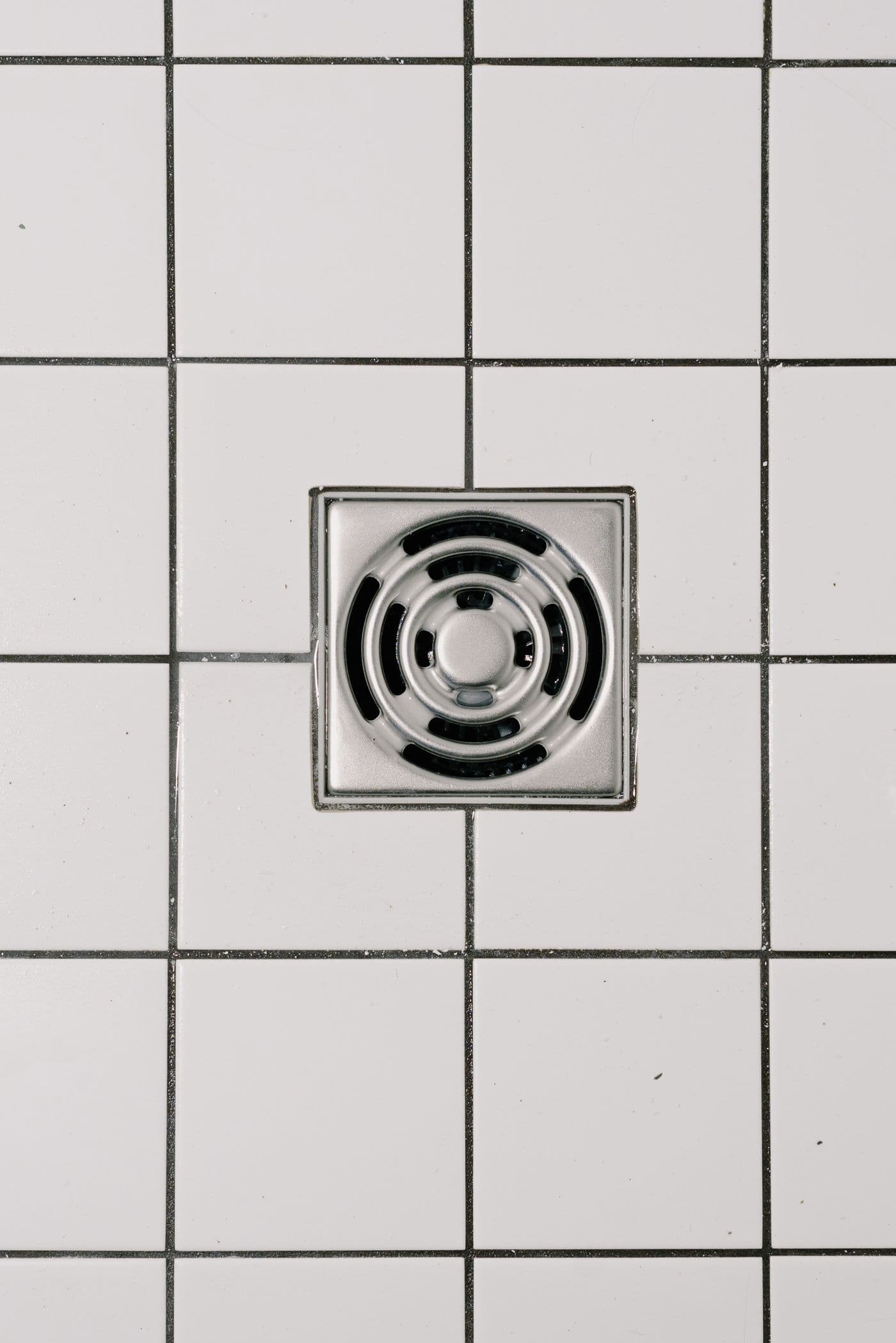 A tiled bathroom floor drain, a common sewage backup point