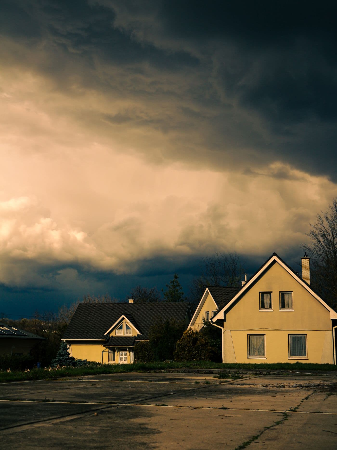 A dark storm front moving in over houses